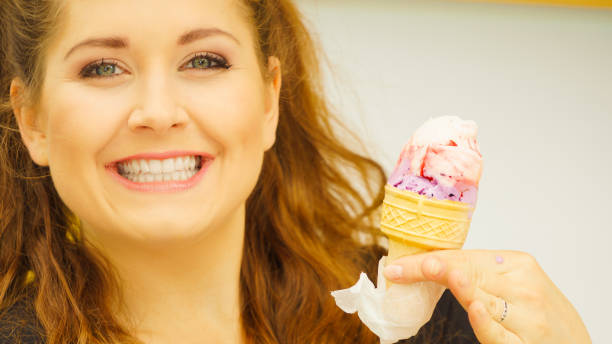 istock Young woman eating ice cream 1064322236