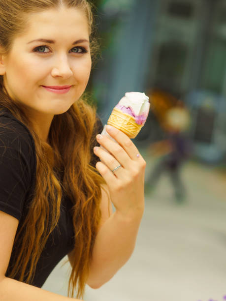 istock Young woman eating ice cream 1064325362