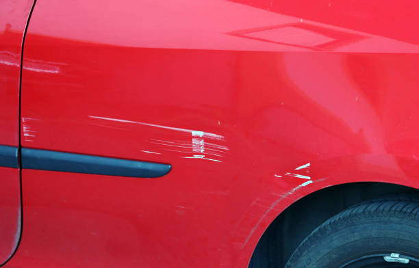 istock Paint scratches on a red car. Accidental damage to a red car 1064325722