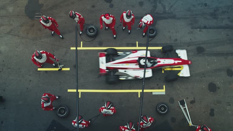 Pit crew repairing racecar during motorsport event