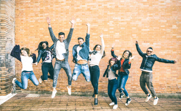 Happy friends millennials jumping and cheering against brick wall in the city - Friendship lifestyle and team concept with young people millenial having fun together - Teal and orange vintage filter Happy friends millennials jumping and cheering against brick wall in the city - Friendship lifestyle and team concept with young people millenial having fun together - Teal and orange vintage filter jumping teenager fun group of people stock pictures, royalty-free photos & images