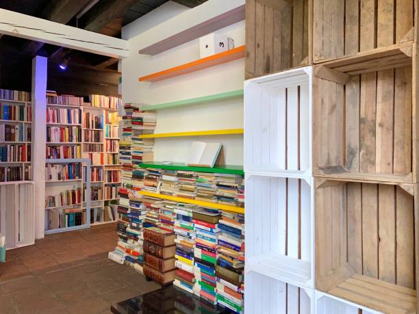 istock Planning the new library - unsorted book stacks and empty shelves 1064339588
