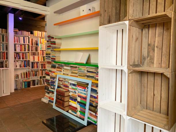 istock Planning the new library - unsorted book stacks and empty shelves 1064339608