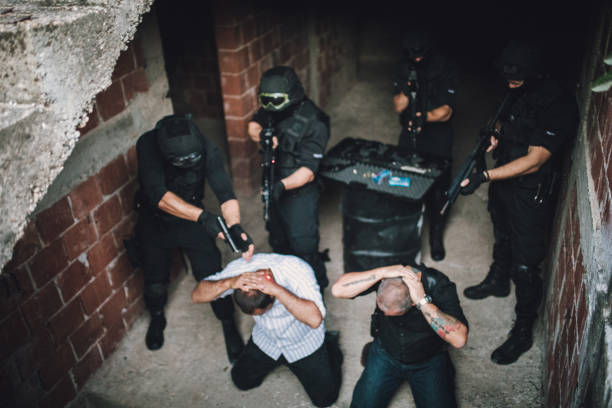 istock Police Arresting Gangster In Warehouse 1064344006