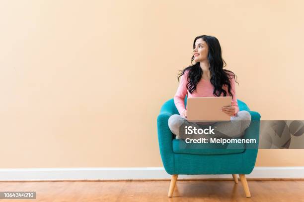 Young Woman Using Her Laptop Stock Photo - Download Image Now - Backgrounds, People, Laptop