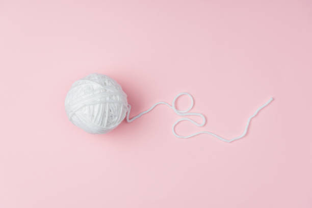 istock top view of white yarn ball for knitting on pink backdrop 1064344696