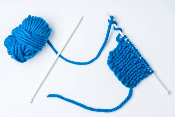 istock top view of blue yarn and knitting needles on white backdrop 1064344856