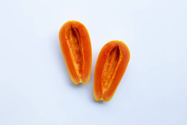 istock Half of ripe papaya fruit on white background, Remove seeds 1064348596