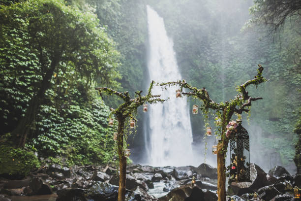 istock Wedding ceremony in jungle with waterfall view 1064351040