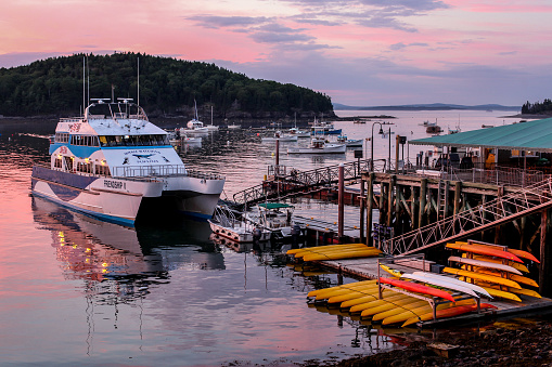 BAR HARBOUR, MAINE, USA - JULY 11, 2013: Beautiful Frenchman Bay sunset with docking boats in Bar Harbor,