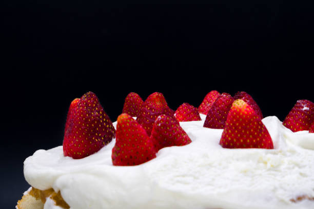 istock Organic strawberry cake with whipped cream isolated on a black background 1064359126