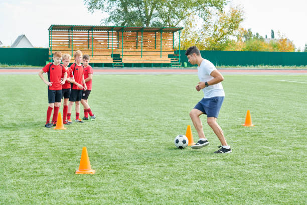 istock Football Coach with Team 1064366160