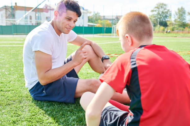 istock Sports Coach Talking to Boy 1064366186