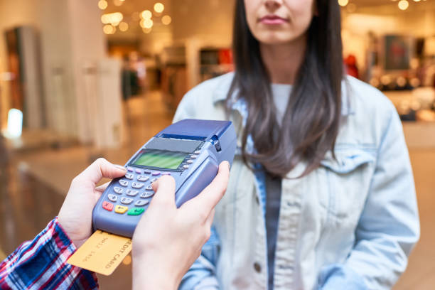 istock Woman paying with credit card 1064366550