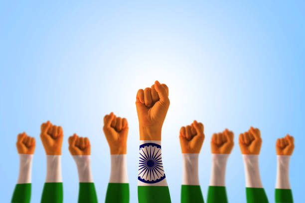 istock India national flag pattern on leader's fist isolated (clipping path) on blue sky for Human equal rights, labor day concept 1064370532