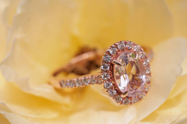istock pink diamond ring on rose flower background 1064370660