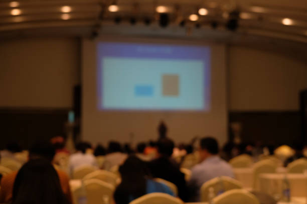 istock audience & stage in seminar conference room. blurry background 1064371004