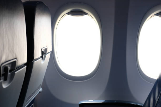 istock airplane window inside cabin. opening aircraft porthole 1064371028