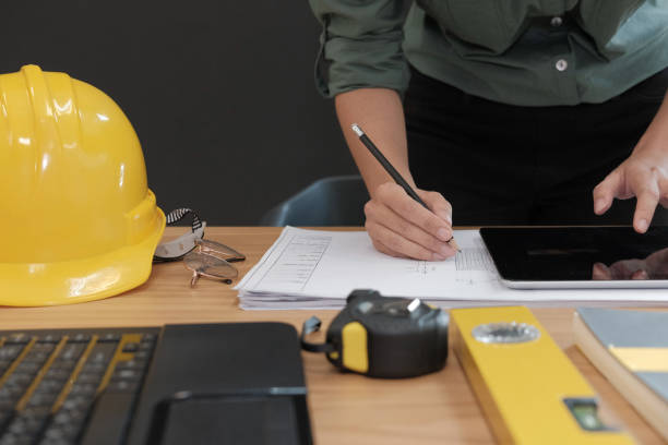 istock architect engineer working on house blueprint of real estate project at workplace. building construction concept 1064371086
