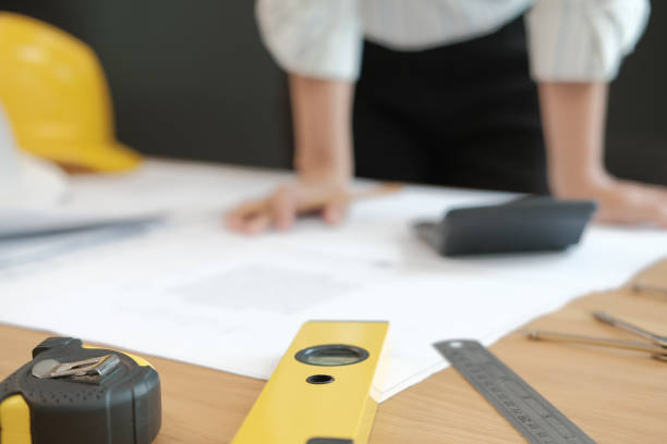 istock architect engineer working on house blueprint of real estate project at workplace. building construction concept 1064371136