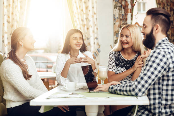 istock Happy friends are resting in cafe drinking coffee 1064372312