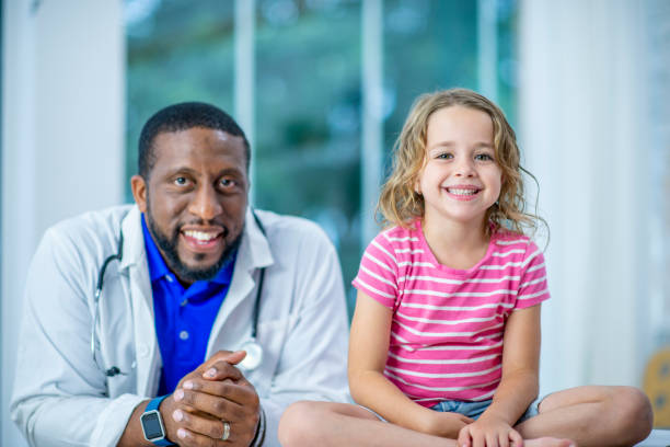 istock Doctor And Girl Smiling Together 1064374516