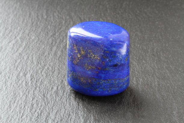 istock A blue lazurite stone on a black stone board 1064379594