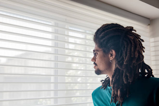 istock Young rastafarian at home looking away thoughtful but sad 1064385302