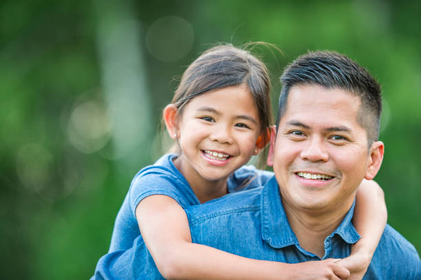istock Young Daughter Hugging Father Outdoors 1064390698