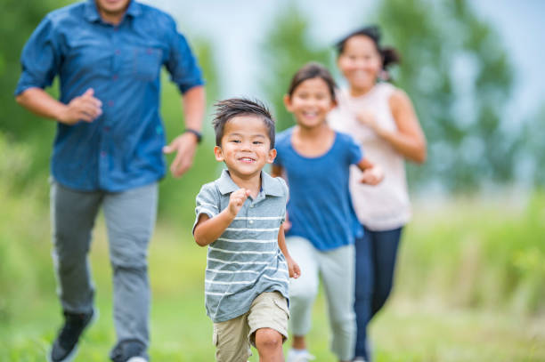 istock Family Running and Playing Outside 1064390700