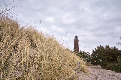 Lighthouse tower at the beach and dunes with beachgrass at Darss island, Germany