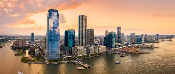 Aerial panorama of Jersey City skyline at sunset.