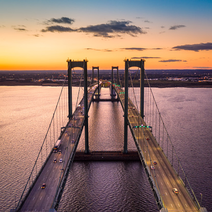 Aerial view of Delaware Memorial Bridge at dusk. The Delaware Memorial Bridge is a set of twin suspension bridges crossing the Delaware River between the states of Delaware and New Jersey
