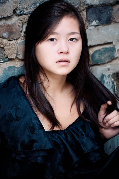 istock Sad girl in front of wall 106440138