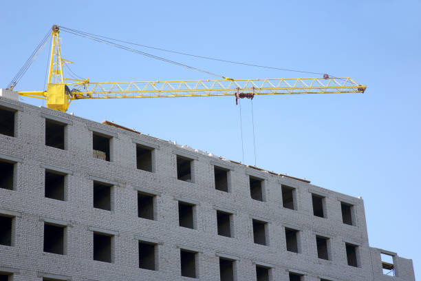 istock Construction crane on the construction of a brick house 1064403100