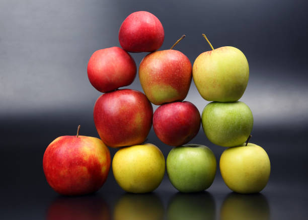 istock Wall of fresh different apples on dark background 1064403444