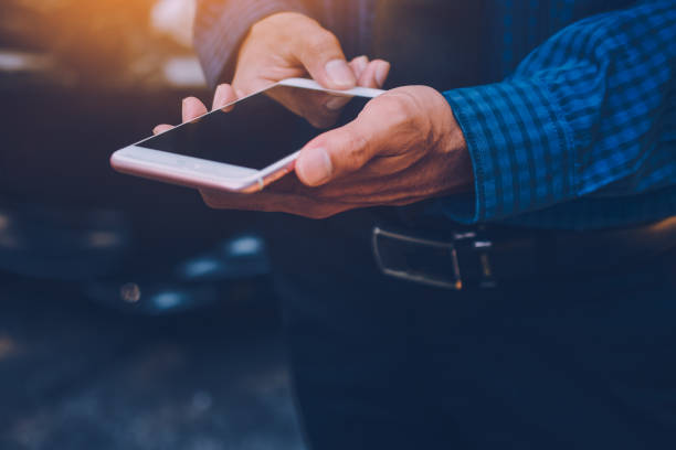 istock Businessman holding smart phone and using  internet online 1064408676