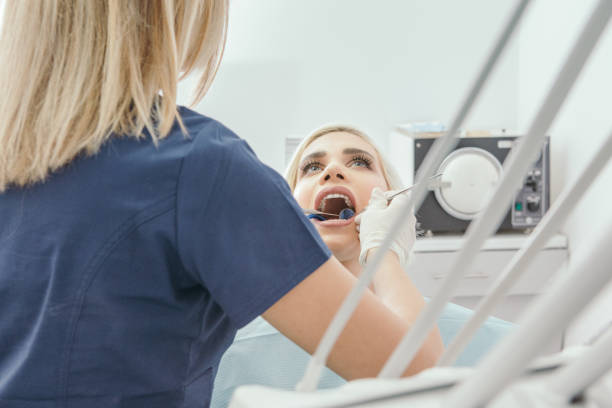 istock Dentist examining a young woman 1064410166