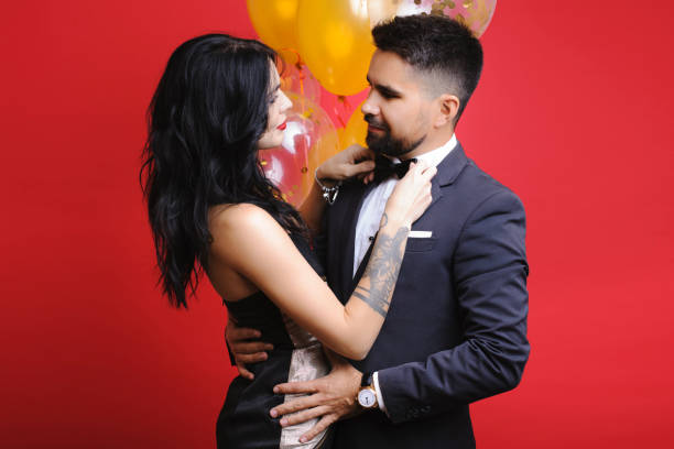 istock Lady adjusting bow tie of man 1064410404