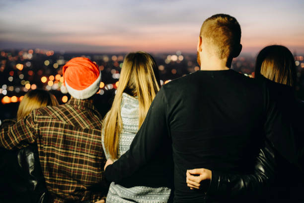 istock Anonymous friends looking at night city 1064410438
