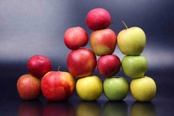 istock Wall of fresh different apples on dark background 1064415824