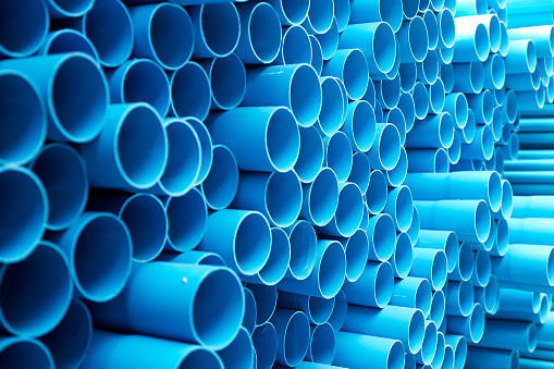 background of colorful  Blue PVC pipes stacked in construction site