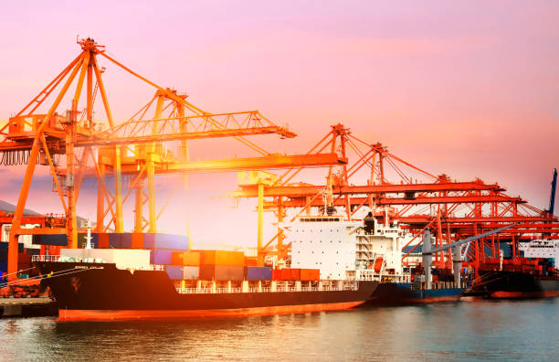 istock container ship at loading port : Logistics and transportation of International Container Cargo ship ,Freight Transportation, Shipping. 1064426412