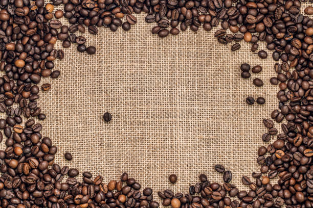 istock Frame made by coffee beans on a sack cloth background 1064427576