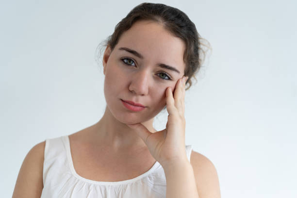 istock Bored lovely woman touching face 1064428062