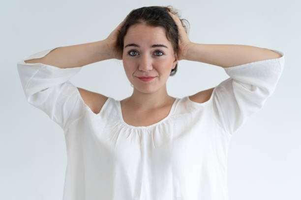 istock Smiling lovely woman clutching head 1064428162