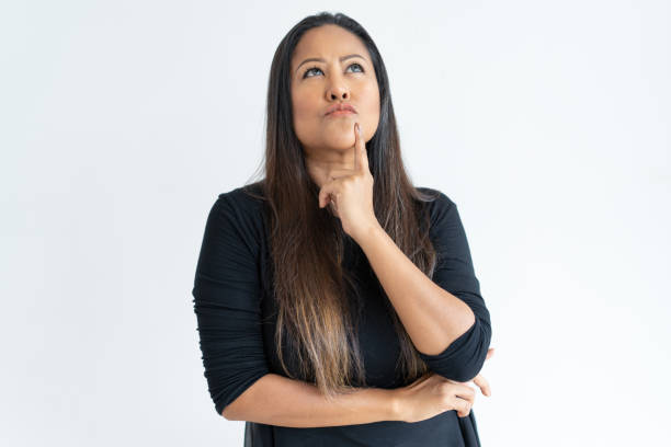 istock Thoughtful middle-aged woman touching chin 1064428212
