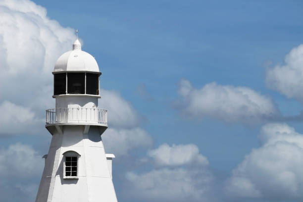 istock A cloud in the blue sky and a lighthouse standing at the harbor 1064430116