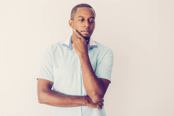 istock Introspective handsome young African man rubbing chin 1064433998