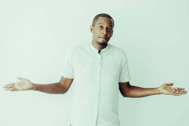 istock Puzzled African man with beard shrugging shoulders 1064434350